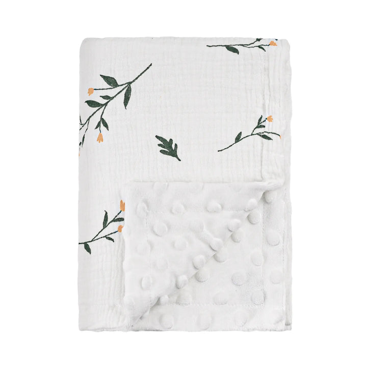 Close-up of a floral baby blanket with soft minky backing, showing off the delicate flower designs and plush texture.